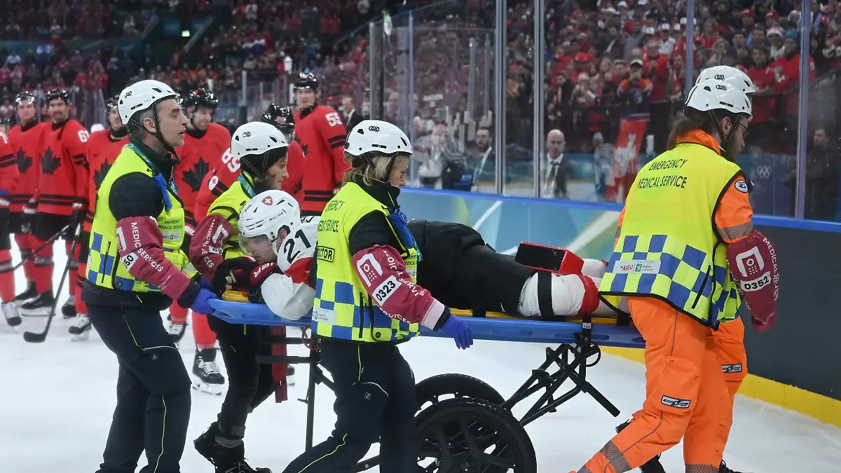 260214-MILAN-Feb-14-2026-Xinhua-Kevin-Fiala-of-Switzerland-is-strechered-off-by-medical-personnel-during-the-ice-hockey-men-s-preliminary-round-group-A-match-between-Canada-and-Switzerland-at-the-Milan-Cortina-2026-Olympic-Winter-Games-in-Milan-Italy-Feb-13-2026