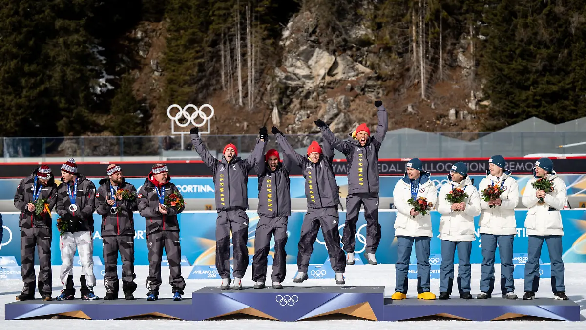260215-Silver-medalists-Christoph-Sumann-Daniel-Mesotitsch-Simon-Eder-and-Dominik-Landertinger-of-Austria-Gold-medalists-Erik-Lesser-Daniel-Boehm-Arnd-Peiffer-and-Simon-Schempp-of-Germany-and-Bronze-medalists-Tarjei-Bø-Johannes-Thingnes-Bø-Ole-Einar-Bjørndalen-and-Emil-Hegle-Svendsen-of-Norway-on-the-podium-during-a-retroactive-medal-ceremony-for-the-Sochi-2014-Winter-Olympics-Biathlon-men-4x7-5km-relay-during-day-9-of-the-2026-Winter-Olympics-on-February-15-2026-in-Anterselva
