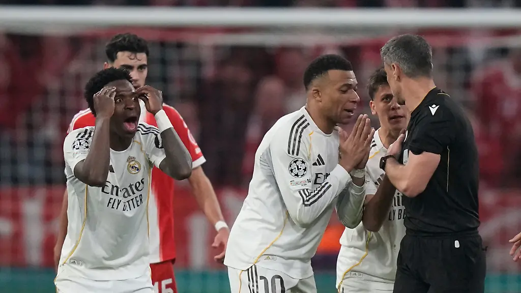Real-Madrid-s-Kylian-Mbappe-center-and-Vinicius-Jr-left-disagree-with-referee-Slavko-Vincic-during-the-Champions-League-quarterfinal-second-leg-soccer-match-between-Bayern-Munich-and-Real-Madrid-in-Munich-Germany-Wednesday-April-15-2026