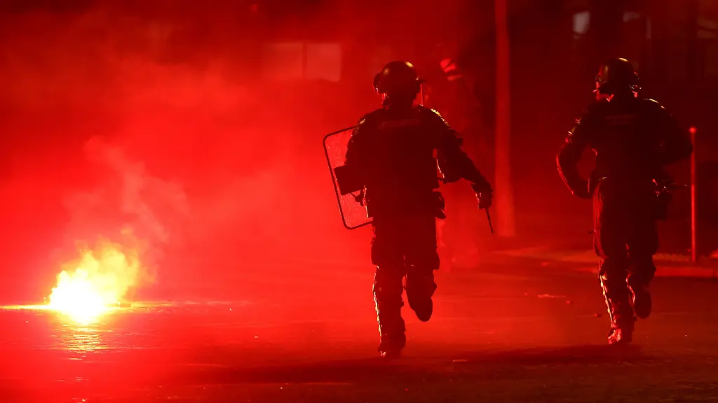 Soccer-Football-UEFA-Champions-League-Paris-St-Germain-fans-celebrate-winning-the-UEFA-Champions-League-Paris-France-May-31-2026-Police-officers-protect-themselves-from-a-flare-after-Paris-St-Germain-won-the-UEFA-Champions-League-REUTERS-Abdul-Saboor