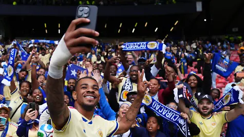 Scotland-v-Curacao-International-Friendly-Hampden-Park-Curacao-s-Juninho-Bacuna-with-fans-following-an-international-friendly-match-at-Hampden-Park-Glasgow-Picture-date-Saturday-May-30-2026-Photo-credit-should-read-Andrew-Milligan-PA-Wire-RESTRICTIONS-Use-subject-to-restrictions-Editorial-use-only-no-commercial-use-without-prior-consent-from-rights-holder