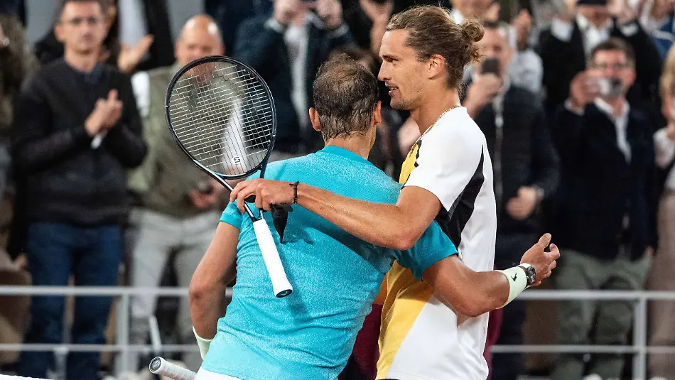 French-Open-Nadal-Loses-On-Possible-Farewell-Spain-s-Rafael-Nadal-R-checks-hands-with-the-winner-Germany-s-Alexander-Zverev-after-their-men-s-singles-match-on-Court-Philippe-Chatrier-on-day-two-of-the-French-Open-tennis-tournament-at-the-Roland-Garros-Complex-in-Paris-on-May-27-2024-Nadal-s-return-to-the-French-Open-and-possible-farewell-ended-at-the-first-hurdle-as-the-14-time-winner-lost-to-Alexander-Zverev-The-22-time-Grand-Slam-champion-was-beaten-6-3-7-6-7-5-6-3-by-the-in-form-German-fourth-seed-Nadal-has-become-synonymous-with-Roland-Garros-but-in-front-of-a-partisan-crowd-he-could-not-replicate-the-level-which-has-made-him-almost-unbeatable-on-the-Paris-clay-Photo-by-Alexis-Jumeau-ABACAPRESS