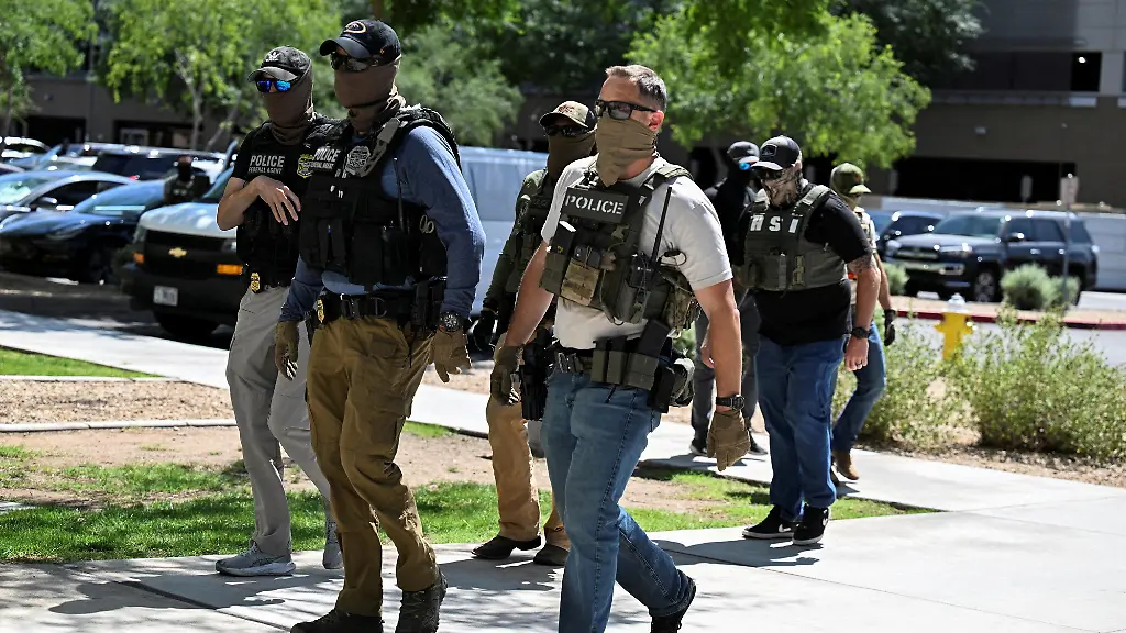 FILE-PHOTO-Masked-law-enforcement-officers-including-HSI-and-ICE-agents-walk-into-an-immigration-court-in-Phoenix-Arizona-U-S-May-21-2025