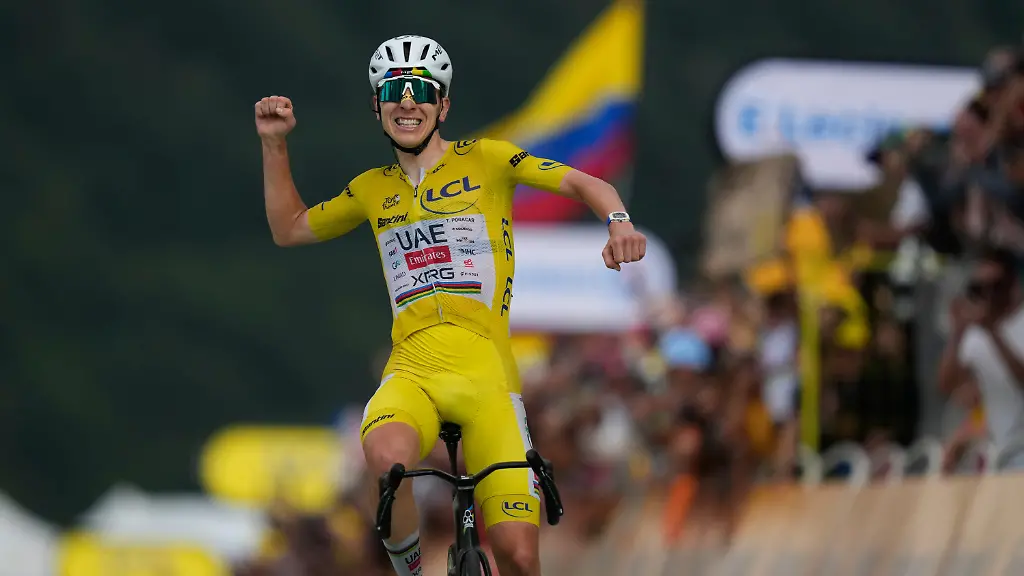 Slovenia-s-Tadej-Pogacar-wearing-the-overall-leader-s-yellow-jersey-celebrates-as-he-crosses-the-finish-line-to-win-the-fourteenth-stage-of-the-Tour-de-France-cycling-race-with-start-in-Mulhouse-and-finish-in-Le-Markstein-Fellering-France-Saturday-July-18-2026