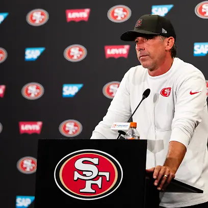 SANTA-CLARA-CA-AUGUST-04-San-Francisco-49ers-Head-Coach-Kyle-Shanahan-speaks-to-the-media-during-San-Francisco-49ers-Training-Camp-on-August-4-2025-at-the-SAP-Performance-Facility-in-Santa-Clara-CA